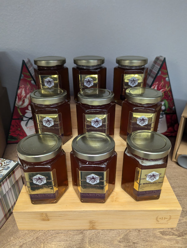 A collection of jarred honey for sale.